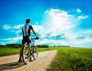 09 bigstock-Man-with-a-Bike-on-Beautiful-N-45559084